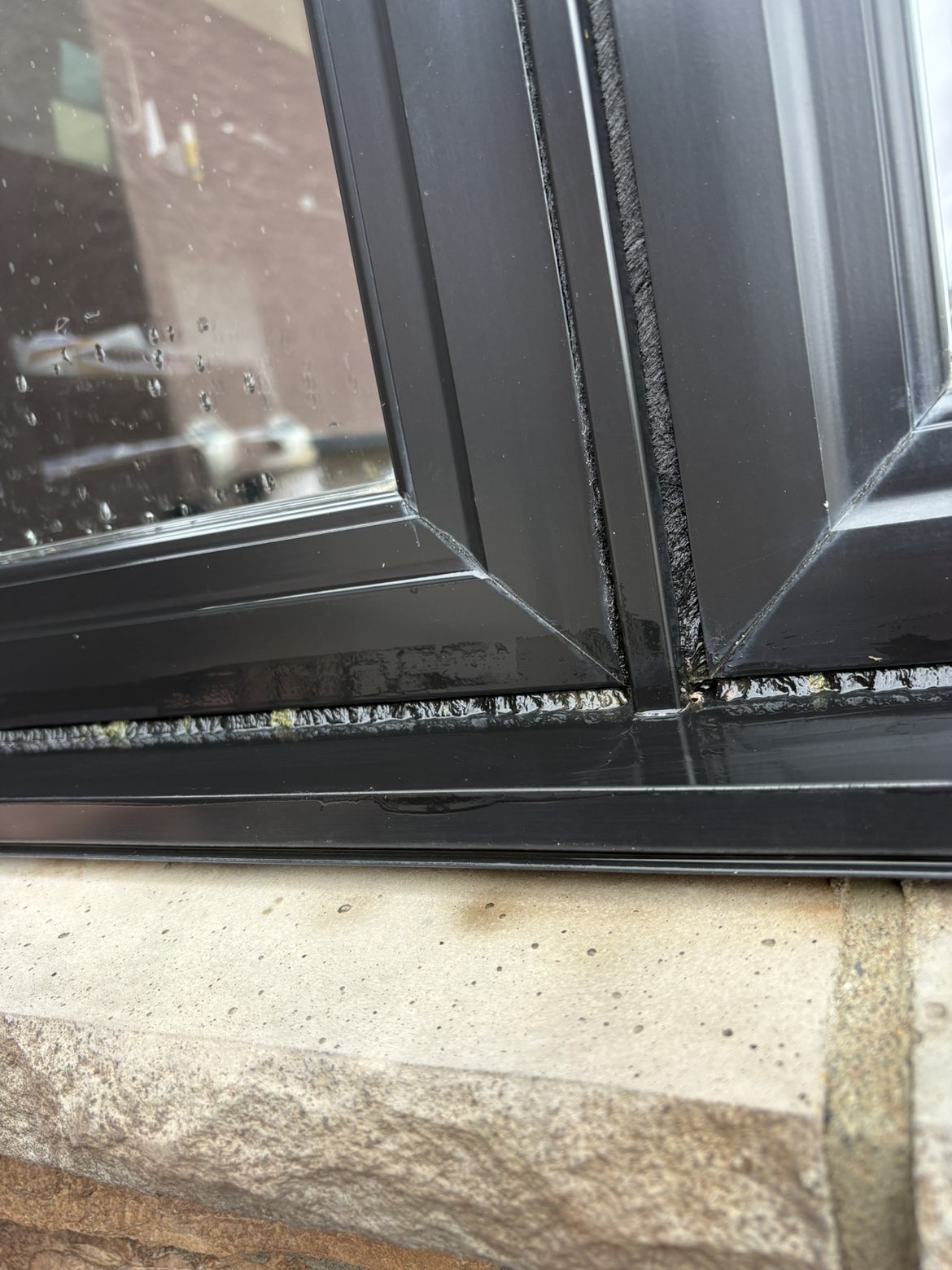 Black window frames and the lower sill after cleaning